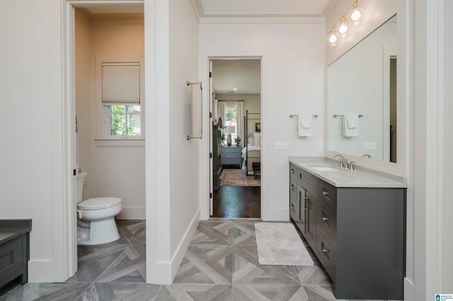 112 Perry Pl, Birmingham, AL 35242 - ensuite bathroom featuring vanity, toilet, crown molding, and baseboards