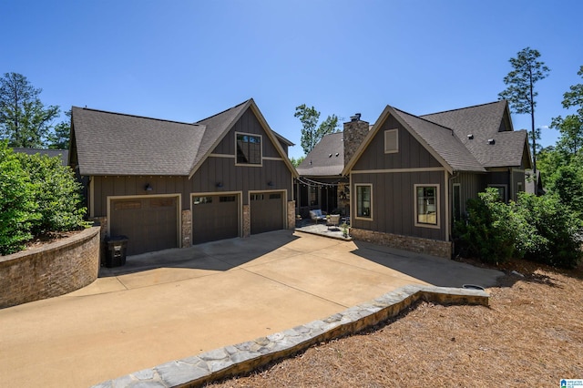 112 Perry Pl, Birmingham, AL 35242 - rustic home featuring board and batten siding, roof with shingles, a chimney, and concrete driveway