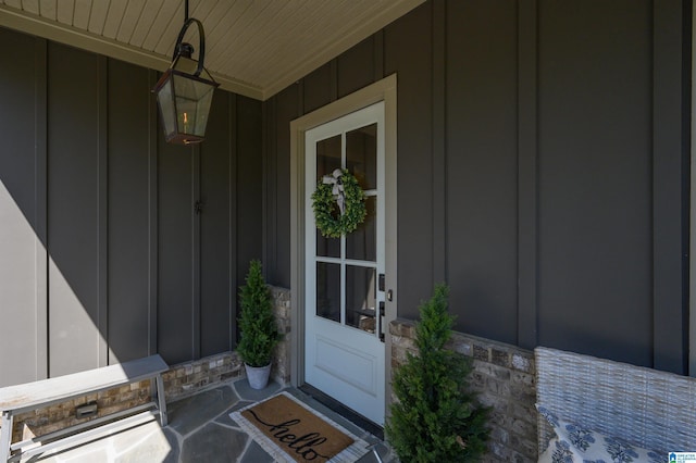 112 Perry Pl, Birmingham, AL 35242 - view of exterior entry featuring board and batten siding, stone siding, and covered porch
