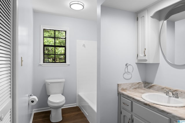 1718 Teakwood Ln, Birmingham, AL 35235 - bathroom featuring toilet, wood finished floors, vanity, baseboards, and a closet