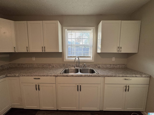804 Elm Ave, Gadsden, AL 35903 - kitchen with a sink, white cabinets, a textured ceiling, and light countertops