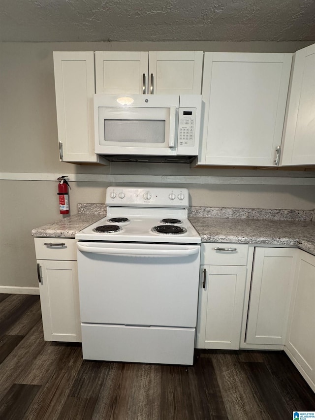 804 Elm Ave, Gadsden, AL 35903 - kitchen featuring white appliances, white cabinets, dark wood-type flooring, and light countertops