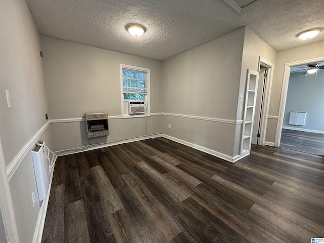 804 Elm Ave, Gadsden, AL 35903 - unfurnished room with heating unit, dark wood-style flooring, a textured ceiling, cooling unit, and baseboards