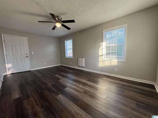 804 Elm Ave, Gadsden, AL 35903 - unfurnished room featuring dark wood-style floors, ceiling fan, baseboards, a textured ceiling, and heating unit