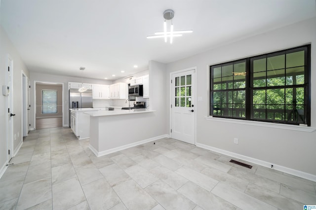 4100 S Shades Crest Rd, Hoover, AL 35244 - kitchen with stainless steel appliances, tasteful backsplash, a peninsula, light countertops, and baseboards