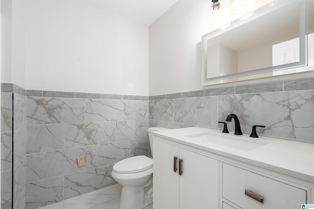4100 S Shades Crest Rd, Hoover, AL 35244 - bathroom with marble look tile flooring, vanity, toilet, tile walls, and a wainscoted wall
