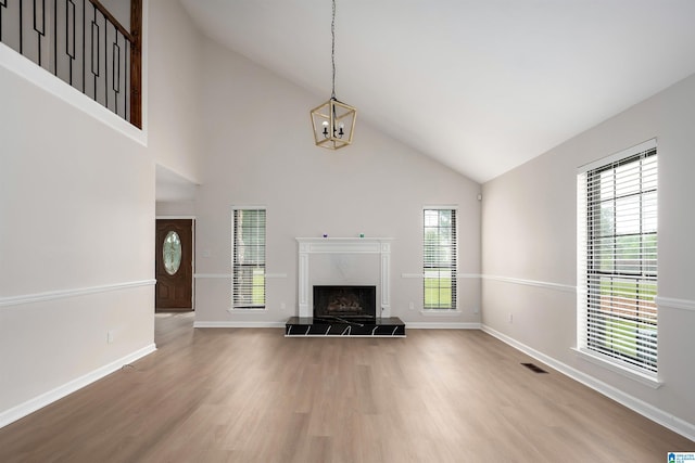 4100 S Shades Crest Rd, Hoover, AL 35244 - living room with wood finished floors, high vaulted ceiling, a high end fireplace, and baseboards