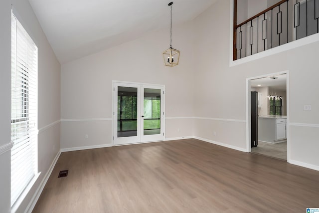 4100 S Shades Crest Rd, Hoover, AL 35244 - unfurnished room featuring a chandelier, french doors, wood finished floors, high vaulted ceiling, and baseboards