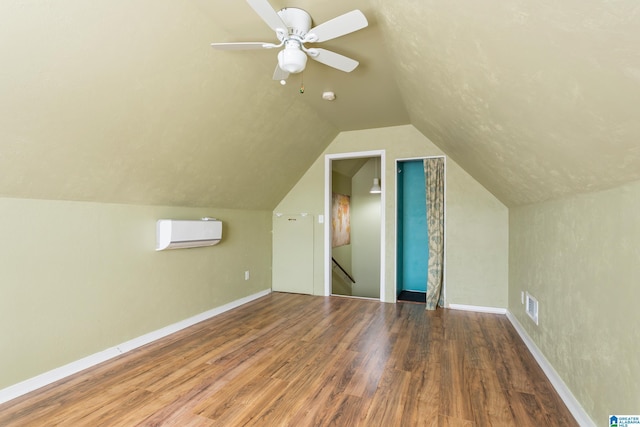 2212 Adkins Cir, Moody, AL 35004 - additional living space featuring a wall mounted air conditioner, wood finished floors, vaulted ceiling, baseboards, and ceiling fan