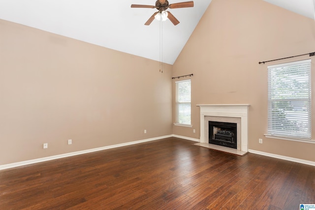 2212 Adkins Cir, Moody, AL 35004 - unfurnished living room featuring high vaulted ceiling, ceiling fan, dark wood-style flooring, baseboards, and a fireplace with flush hearth