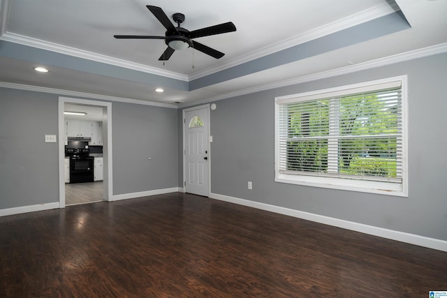 140 Camelia Ave, Gardendale, AL 35071 - unfurnished living room featuring baseboards, dark wood finished floors, a tray ceiling, a ceiling fan, and ornamental molding