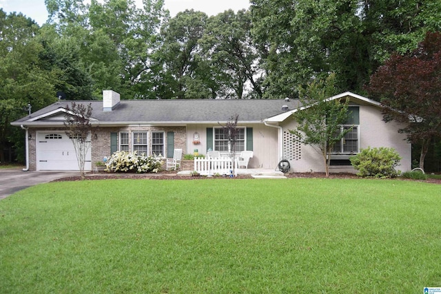 3908 Cloverdale Rd, Anniston, AL 36207 - single story home featuring a garage, brick siding, a front yard, asphalt driveway, and a chimney