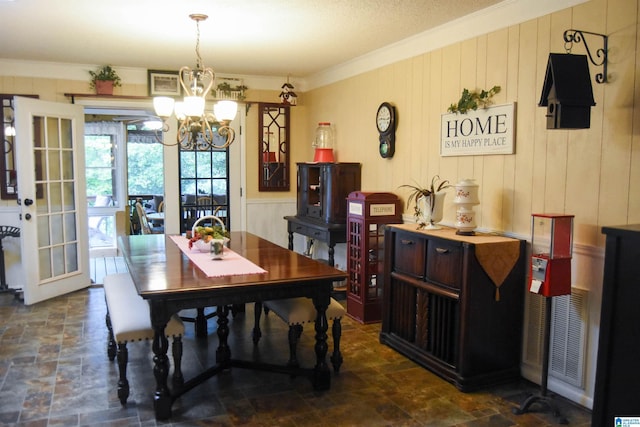 3908 Cloverdale Rd, Anniston, AL 36207 - dining space with stone finish floors, a chandelier, crown molding, and wood walls