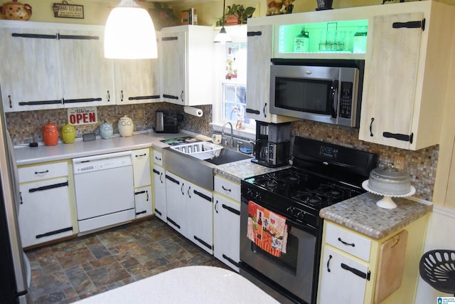 3908 Cloverdale Rd, Anniston, AL 36207 - kitchen featuring range with gas cooktop, stainless steel microwave, dishwasher, a sink, and tasteful backsplash
