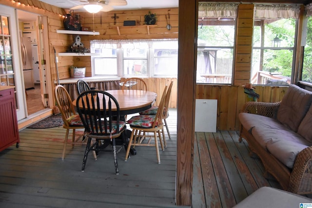 3908 Cloverdale Rd, Anniston, AL 36207 - dining area featuring hardwood / wood-style flooring, wooden walls, plenty of natural light, and ceiling fan