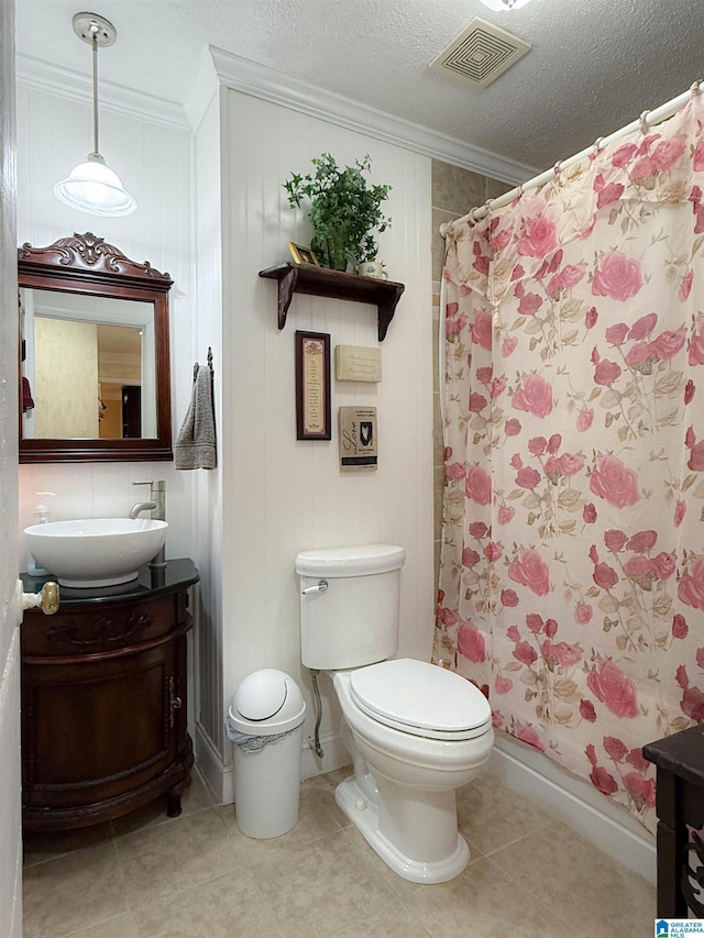 3908 Cloverdale Rd, Anniston, AL 36207 - full bath featuring crown molding, vanity, toilet, a shower with shower curtain, and tile patterned flooring