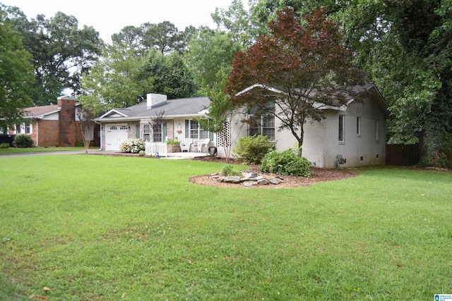 3908 Cloverdale Rd, Anniston, AL 36207 - ranch-style home with an attached garage, a front yard, a chimney, and brick siding