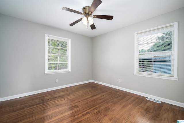 1644 1st St NE, Center Point, AL 35215 - spare room featuring dark wood finished floors, baseboards, and a ceiling fan