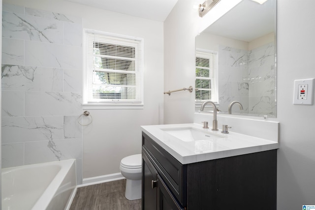 1644 1st St NE, Center Point, AL 35215 - full bathroom featuring vanity, toilet, wood finished floors, baseboards, and shower / tub combination