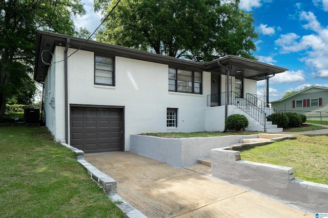 1644 1st St NE, Center Point, AL 35215 - view of front of house featuring a garage, brick siding, driveway, and a front lawn