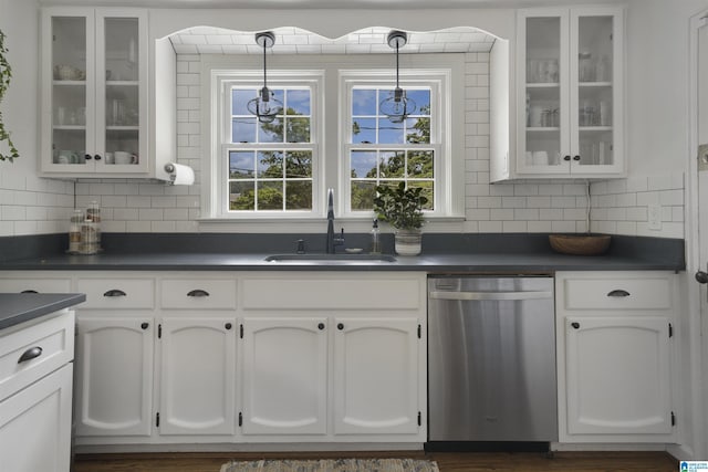 39 Edgehill Rd, Homewood, AL 35209 - kitchen with stainless steel dishwasher, a sink, dark countertops, decorative backsplash, and white cabinetry