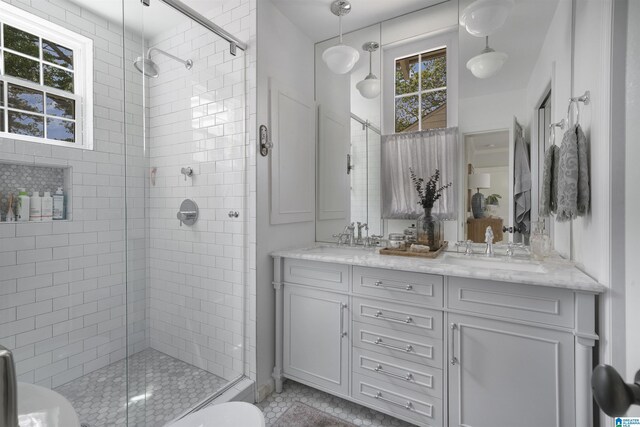 39 Edgehill Rd, Homewood, AL 35209 - full bathroom with a shower stall, double vanity, tile patterned flooring, and toilet