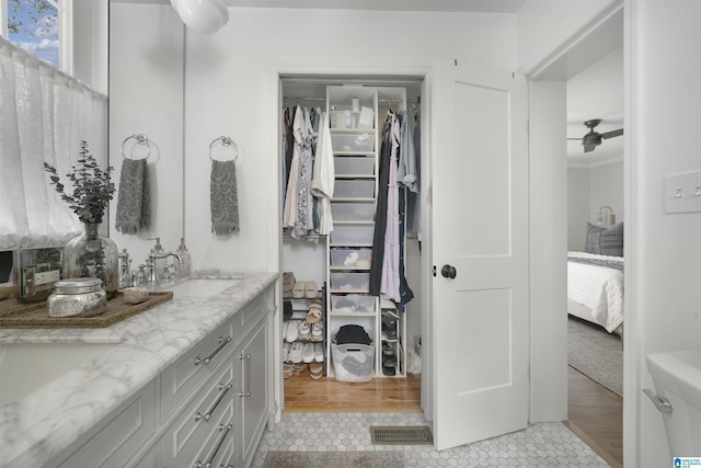 39 Edgehill Rd, Homewood, AL 35209 - ensuite bathroom with double vanity, tile patterned floors, a spacious closet, and ornamental molding