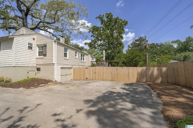 39 Edgehill Rd, Homewood, AL 35209 - view of home's exterior with a chimney, a gate, and a garage
