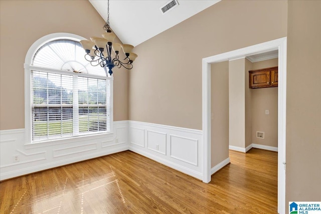 555 Ridgefield Way, Odenville, AL 35120 - spare room featuring healthy amount of natural light, a chandelier, wainscoting, light wood finished floors, and vaulted ceiling