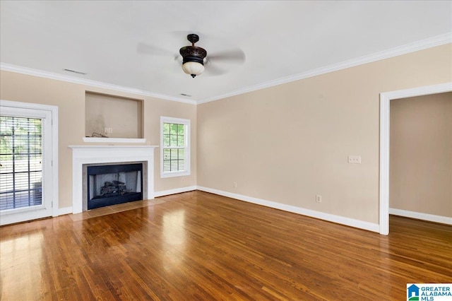 555 Ridgefield Way, Odenville, AL 35120 - unfurnished living room featuring ceiling fan, wood finished floors, baseboards, ornamental molding, and a fireplace with flush hearth