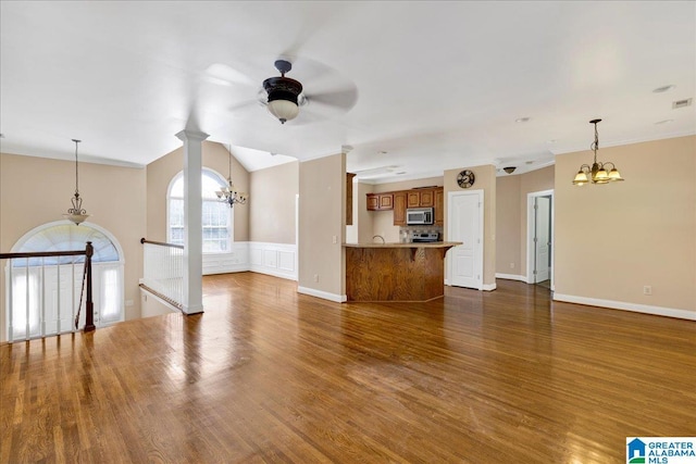 555 Ridgefield Way, Odenville, AL 35120 - unfurnished living room with a chandelier, a ceiling fan, dark wood-style floors, wainscoting, and baseboards