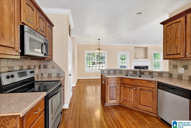 555 Ridgefield Way, Odenville, AL 35120 - kitchen with appliances with stainless steel finishes, a sink, wood finished floors, a peninsula, and brown cabinetry