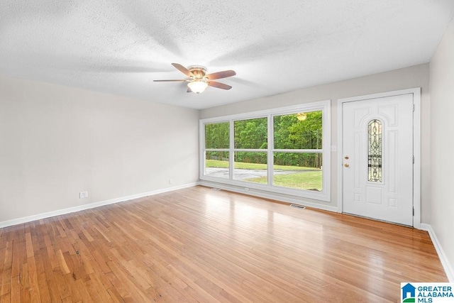 4010 93rd St, Northport, AL 35473 - entrance foyer with a ceiling fan, light wood-style floors, baseboards, and a textured ceiling