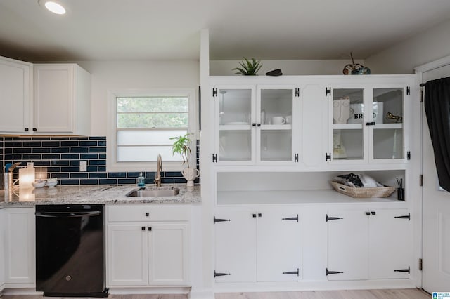 1320 Monticello St, Irondale, AL 35210 - kitchen featuring a sink, dishwasher, white cabinetry, glass insert cabinets, and light stone countertops