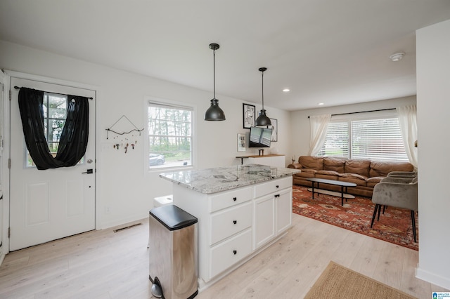 1320 Monticello St, Irondale, AL 35210 - kitchen with light wood finished floors, healthy amount of natural light, open floor plan, white cabinetry, and recessed lighting
