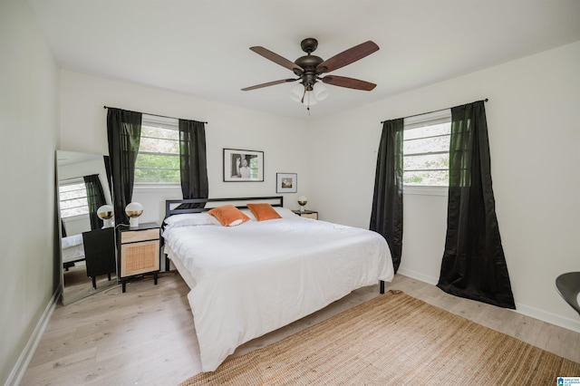 1320 Monticello St, Irondale, AL 35210 - bedroom with light wood-type flooring, multiple windows, baseboards, and ceiling fan