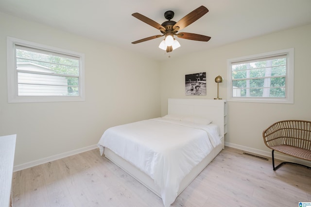 1320 Monticello St, Irondale, AL 35210 - bedroom featuring multiple windows, light wood-style floors, and baseboards