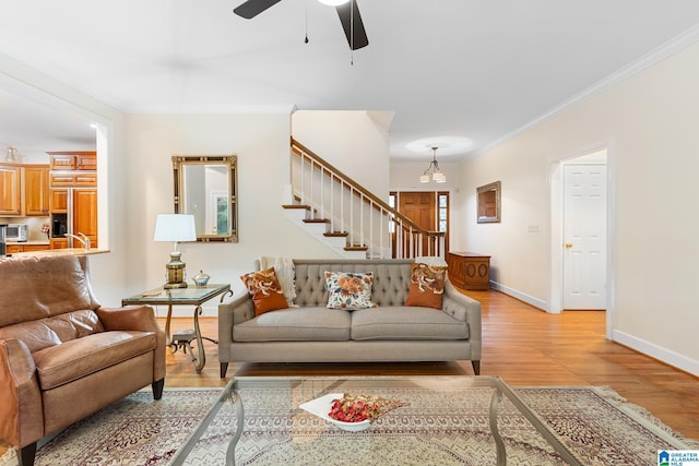 919 Sycamore Dr, Hoover, AL 35244 - living area featuring light wood-style flooring, a ceiling fan, baseboards, crown molding, and stairway