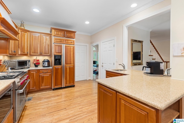919 Sycamore Dr, Hoover, AL 35244 - kitchen featuring high quality appliances, custom exhaust hood, a sink, light wood-style flooring, and brown cabinets