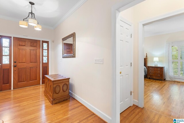 919 Sycamore Dr, Hoover, AL 35244 - entrance foyer featuring light wood-style flooring, ornamental molding, baseboards, and a chandelier