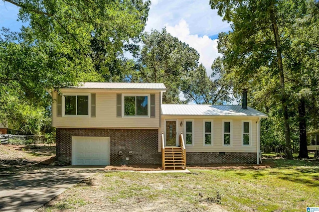 941 Honeysuckle Ln, Moody, AL 35094 - tri-level home with concrete driveway, a garage, crawl space, metal roof, and brick siding