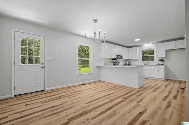 941 Honeysuckle Ln, Moody, AL 35094 - kitchen featuring appliances with stainless steel finishes, a chandelier, white cabinets, healthy amount of natural light, and recessed lighting