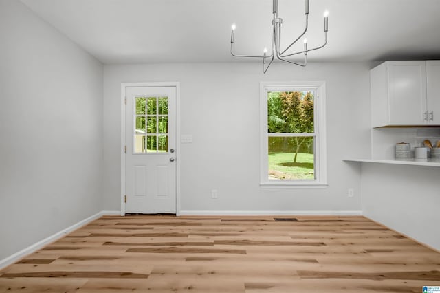 941 Honeysuckle Ln, Moody, AL 35094 - unfurnished dining area with wood finished floors, a chandelier, and healthy amount of natural light