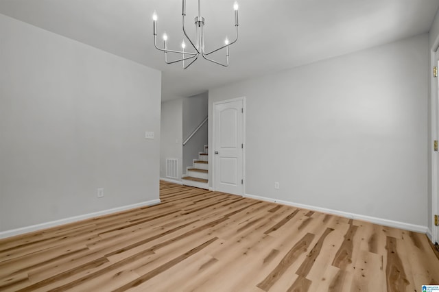 941 Honeysuckle Ln, Moody, AL 35094 - unfurnished room featuring stairway, a chandelier, baseboards, and light wood-style floors