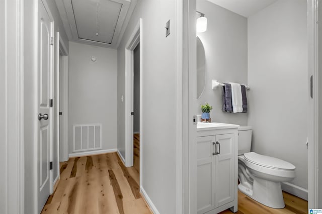 941 Honeysuckle Ln, Moody, AL 35094 - bathroom featuring wood finished floors, toilet, vanity, and baseboards