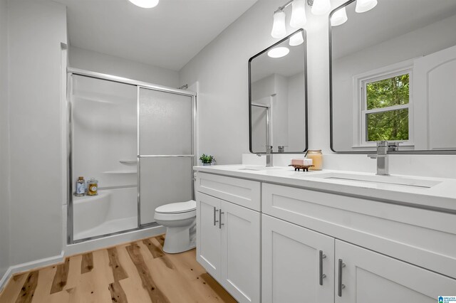 941 Honeysuckle Ln, Moody, AL 35094 - bathroom with a shower stall, double vanity, wood finished floors, and toilet
