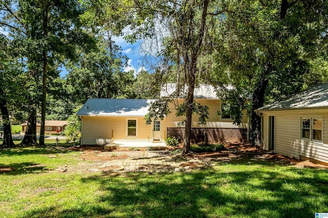 941 Honeysuckle Ln, Moody, AL 35094 - back of house with a yard and metal roof