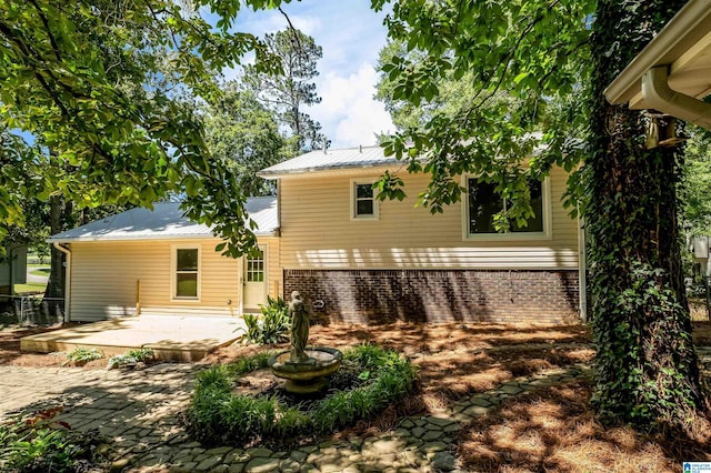 941 Honeysuckle Ln, Moody, AL 35094 - rear view of house with a patio area, metal roof, and brick siding