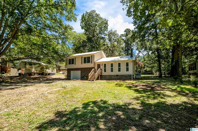 941 Honeysuckle Ln, Moody, AL 35094 - back of property with an attached garage and a yard