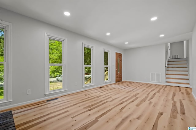 941 Honeysuckle Ln, Moody, AL 35094 - unfurnished living room with healthy amount of natural light, recessed lighting, light wood-style floors, stairs, and baseboards